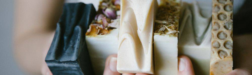 Anna the creator of Chanconette natural soaps for babies, toddlers and adults is holding a selection of hand-made soaps with different natural ingredients.  