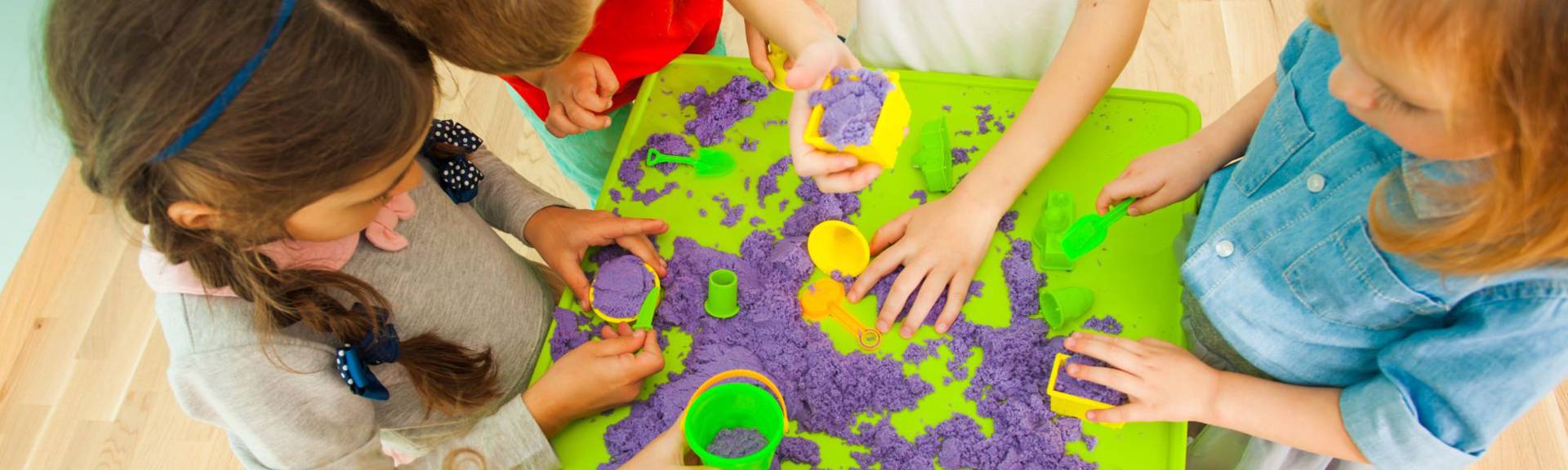 Children engaged in hands-on learning activities at Cleverkidz, using educational toys and materials in a bright, playful classroom setting.”