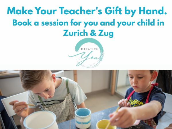 Two young boys focused on painting their own ceramic mugs at Creative You pottery studio near Zurich and Zug — a hands-on parent and child experience to create a one-of-a-kind handmade gift for their teacher.
