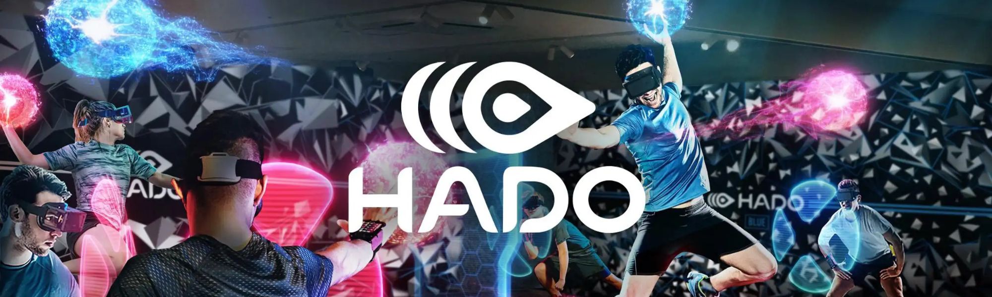 Promotional banner for HADO, an augmented reality (AR) sports game, featuring players wearing AR headsets and arm-mounted controllers. The players are actively engaged, throwing and blocking glowing virtual energy balls in vibrant blue and pink hues. The background is a dark, geometric pattern with futuristic lighting effects, emphasizing the immersive and dynamic nature of the game.
