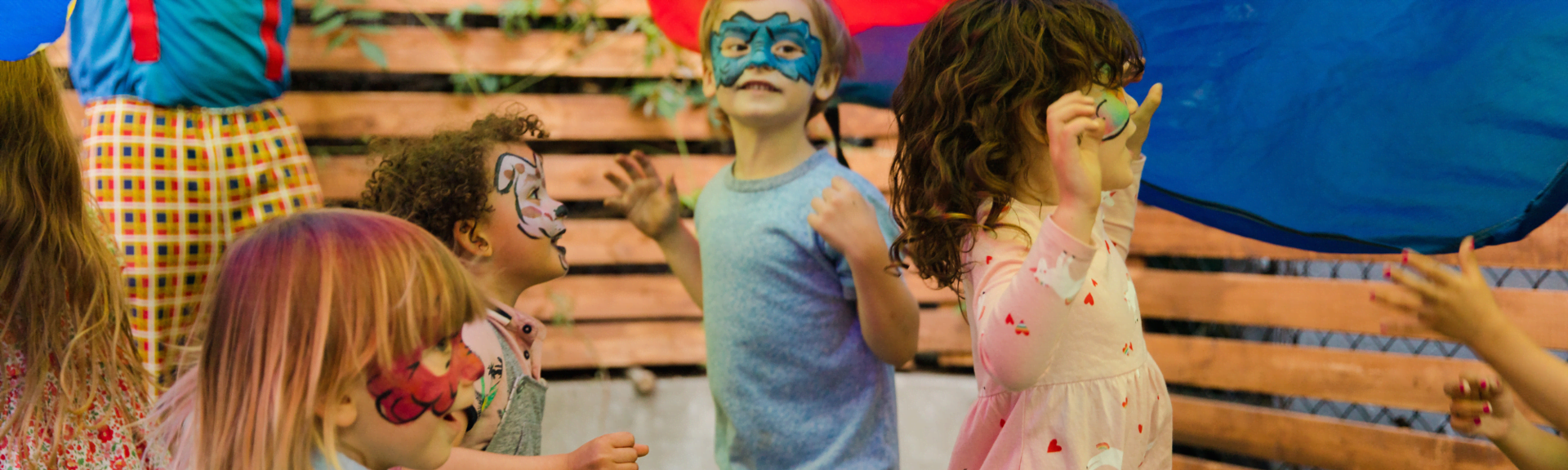 Children dancing around with facepainting at Hocus Pocus Paidotopos in Athens