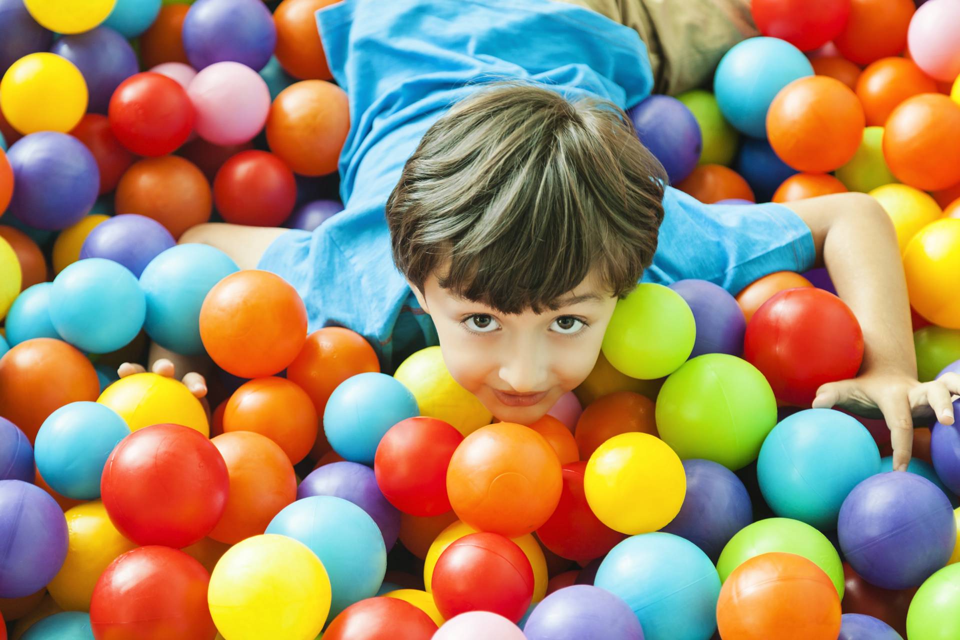 boy in ball pool indoor playground