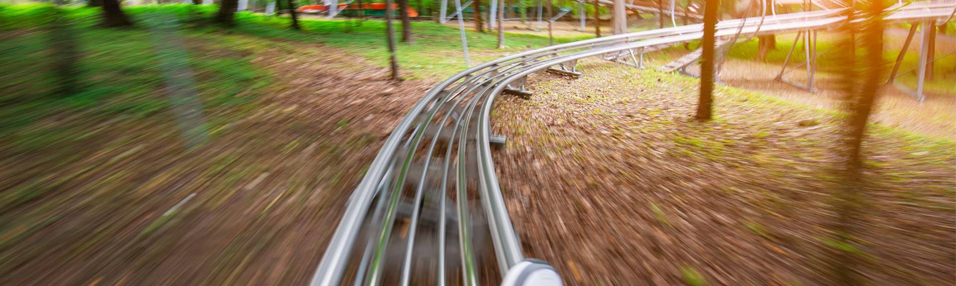 Rider enjoying the summer toboggan run at Fräkmüntegg on Mount Pilatus near Lucerne, Switzerland, gliding down a scenic alpine track with mountain views.