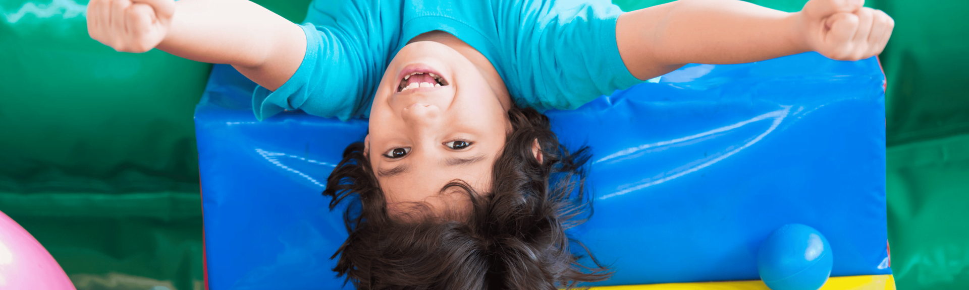 A boy having fun on a trampoline while being upside down on it