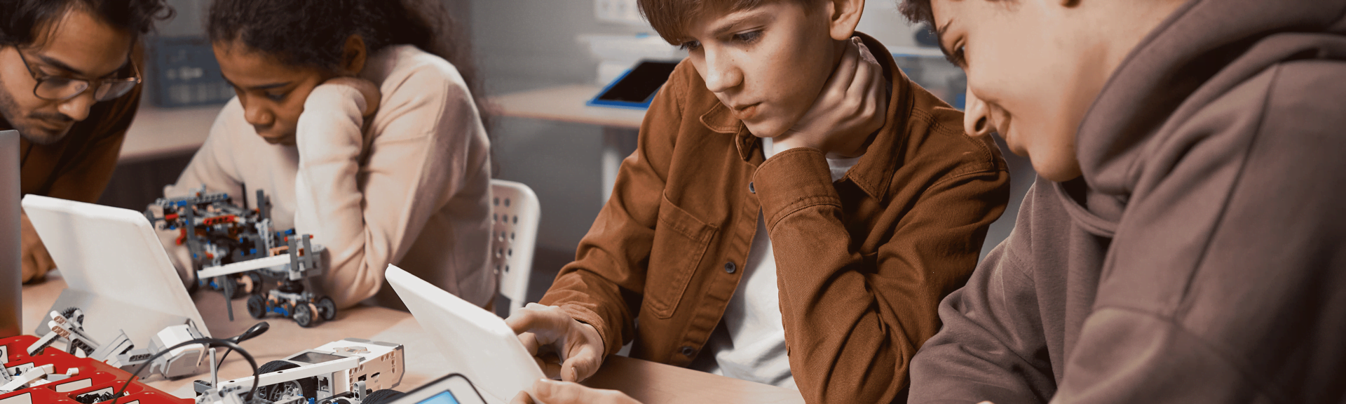 A team of young teens, girls and boys, are creating apps, exploring generative AI and building games at one of the short courses offered by Logiscool in Zurich, Switzerland.  