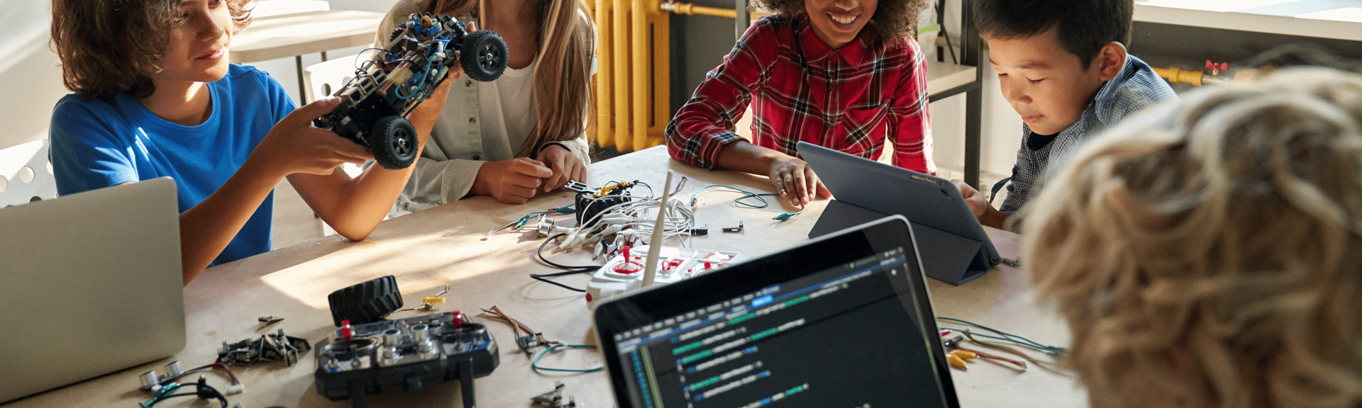 A team of young teens, girls and boys, are creating apps, exploring generative AI and building games at one of the short courses offered by Logiscool in Zurich, Switzerland.  