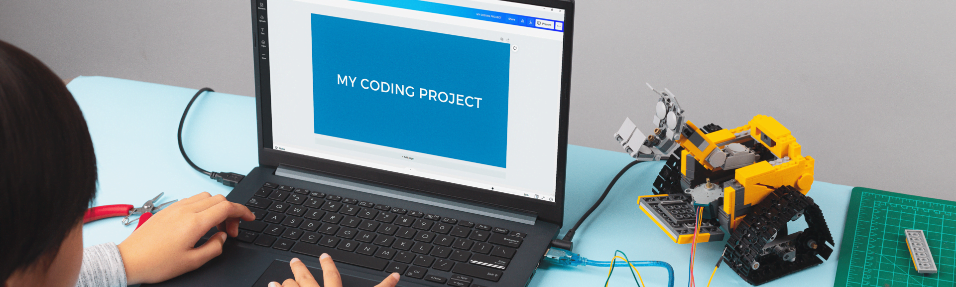 A class of teenage boys and girls programming software and a robot at the robotics camp of Techspark Academy in Zurich. 