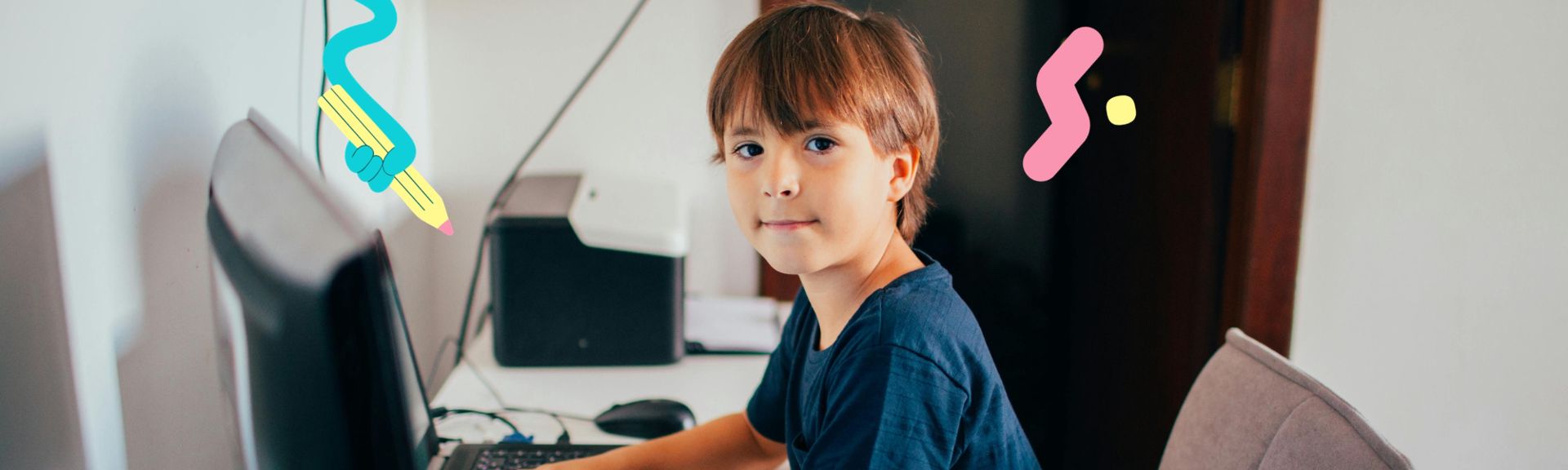 A young boy sits at a desk looking over his shoulder at the camera, with a laptop and desktop monitor in front of him, decorated with playful teal pencil and pink squiggle graphic elements.