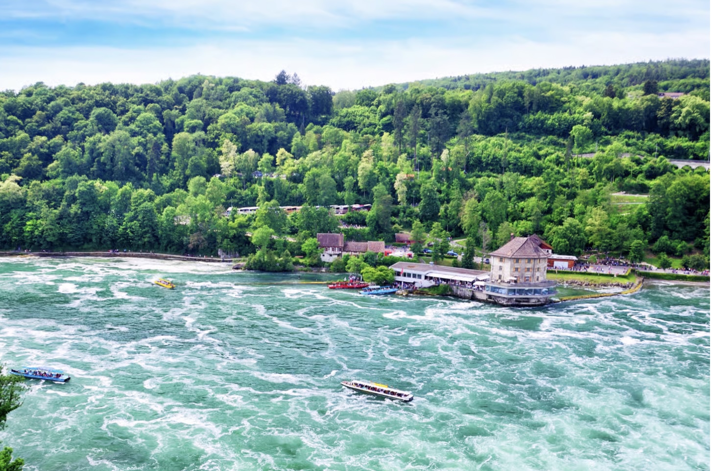 Aerial view of the Rhine Falls with boats and Schlössli Wörth, a top spot for a family excursion in Switzerland