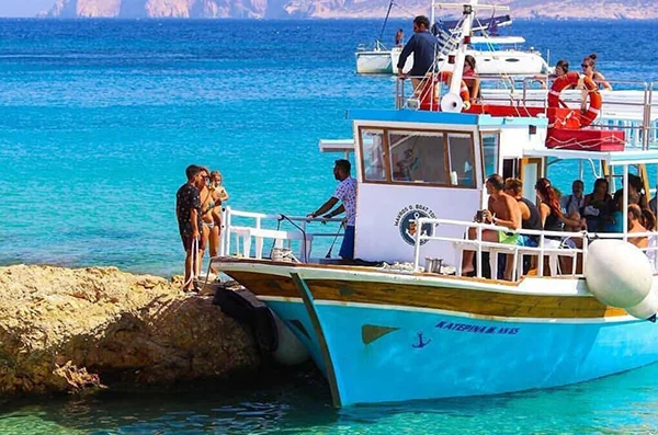 Guests boarding the Mavros G Boat Tours boat at a Koufonisia cove