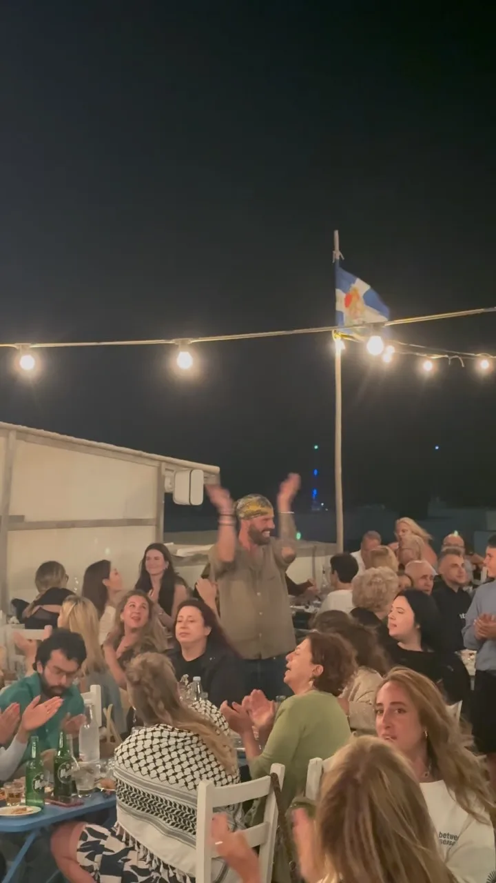 Guests at outdoor tables under string lights at Stou Lolou