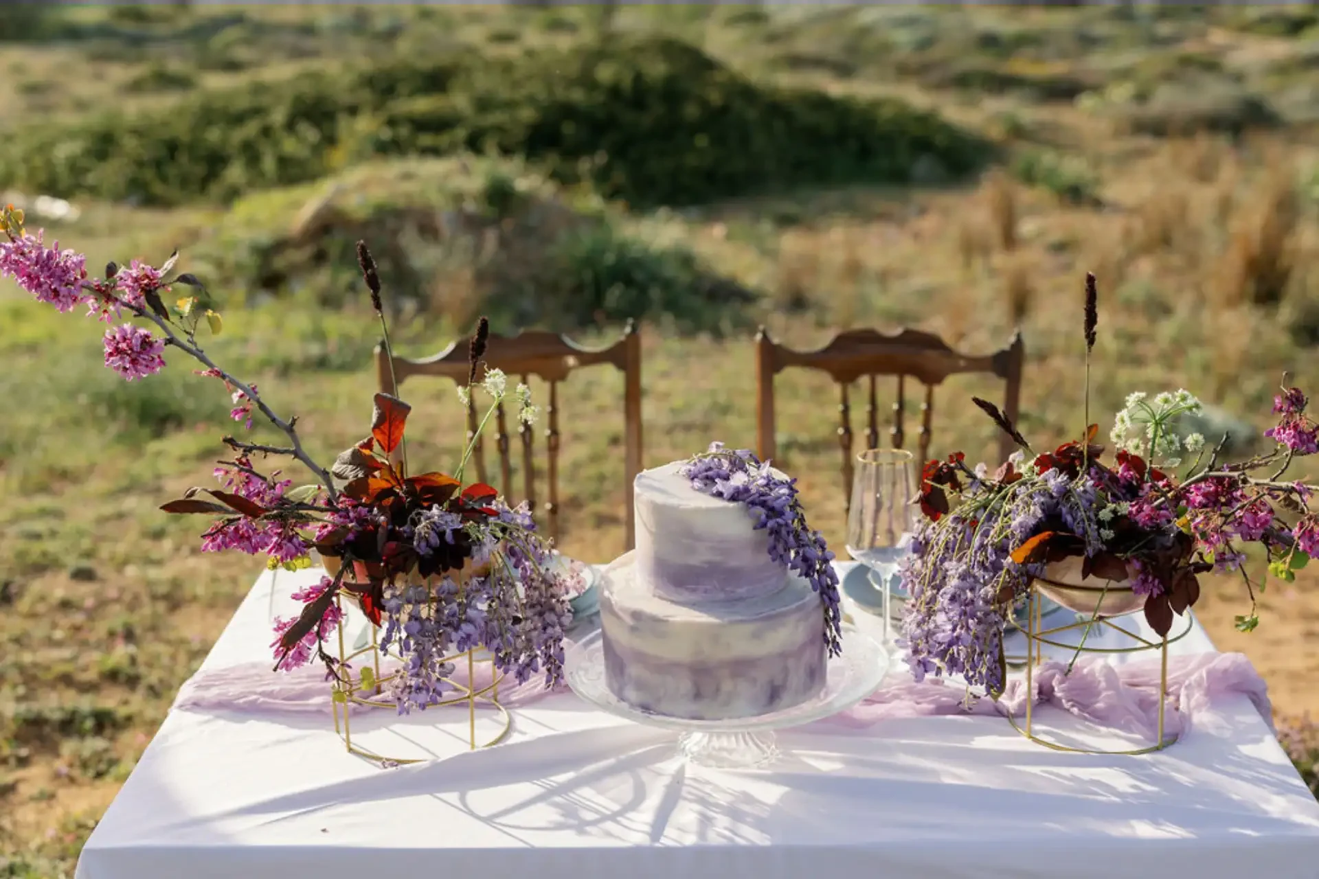 Wedding Tales Crete, τραπέζι elopement με λιλά λουλούδια πάνω από τη θάλασσα